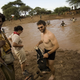 New York Times correspondent Jeffrey Gettleman, in Somalia crossing a river with rebel fighter Commander Peacock, a “heavily armed dreamer.” (KenyaBuzz)
